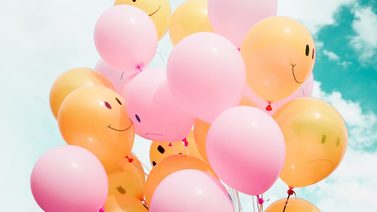 balloons with smiley and sad faces