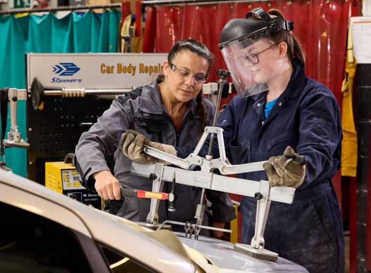 WorldSkills Ambassador and Motor Vehicle Curriculum Team Leader Claire Evans helping a student in the workshop.
