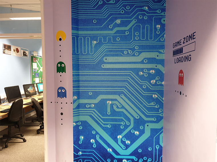 Computing corridor with wall graphics.