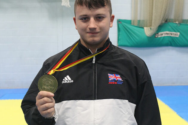 Michael Lomas holds his medal