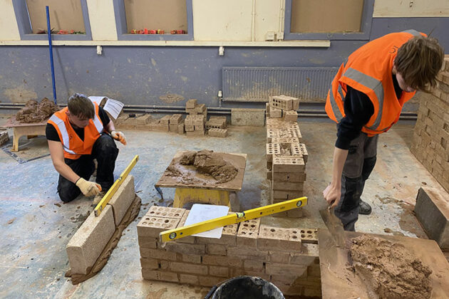 Construction students taking part in the brick pressure test competitions
