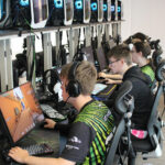 An esports students sat in front of a computer