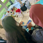 Students sat at a table doing some sustainability artwork