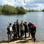A group of people stood next to Manvers Lake