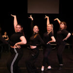 A group of performance students stood in a pose