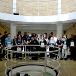 A large group of people stood together in a large room