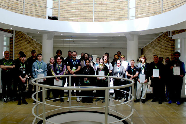 A large group of people stood together in a large room