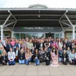 A large group of people gathered outside the front of Dearne Valley College's entrance