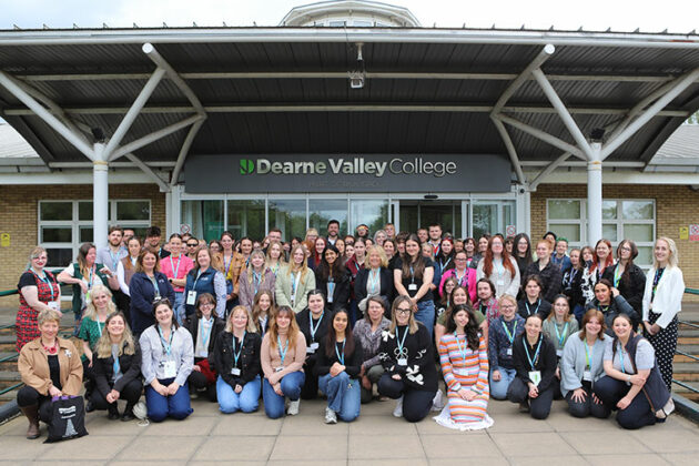 A large group of people gathered outside the front of Dearne Valley College's entrance